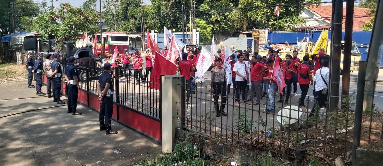 SAGAS security guards deployed at client site main gate during demonstration, coordinating with local police in Indonesia