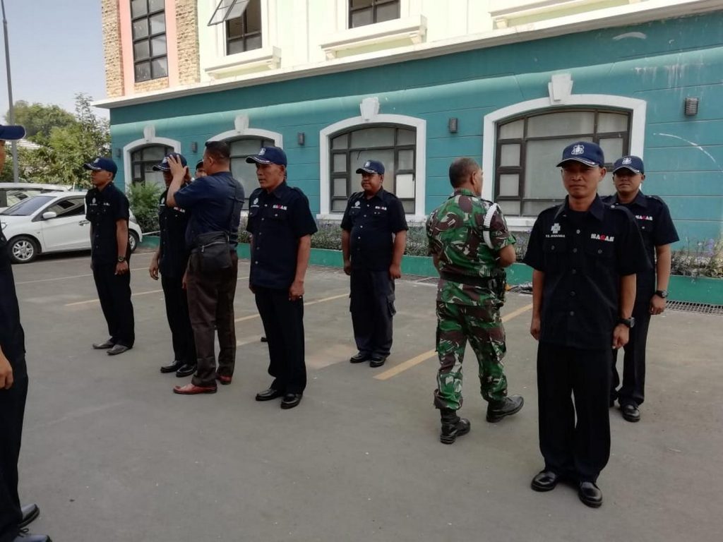 Senior SAGAS security guards participating in supervisory drill with instructor in military attire at training facility in Indonesia to enhance leadership and operational skills