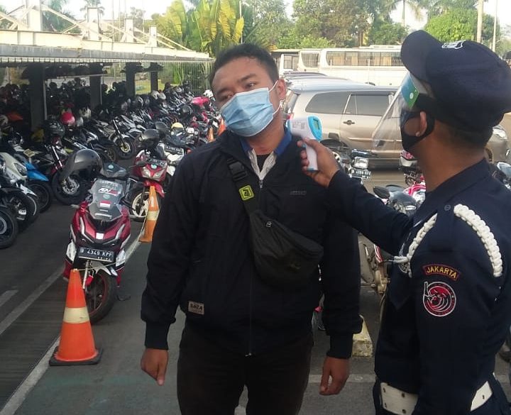 SAGAS security guard conducting health and safety screening for visitors at a client site in Indonesia