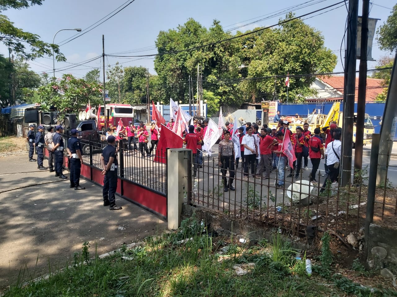 SAGAS security guards on alert at client site main entrance during public demonstration in Indonesia