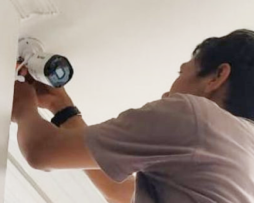 staff installing CCTV camera at customer location